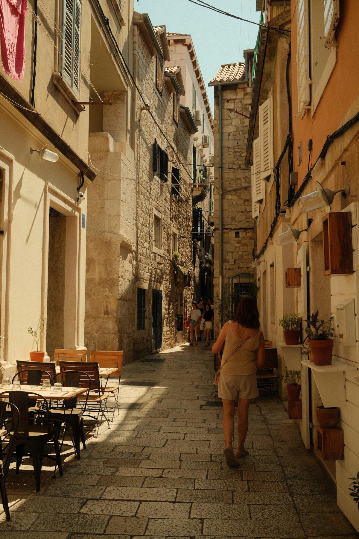 Narrow street in Split with rustic cafes