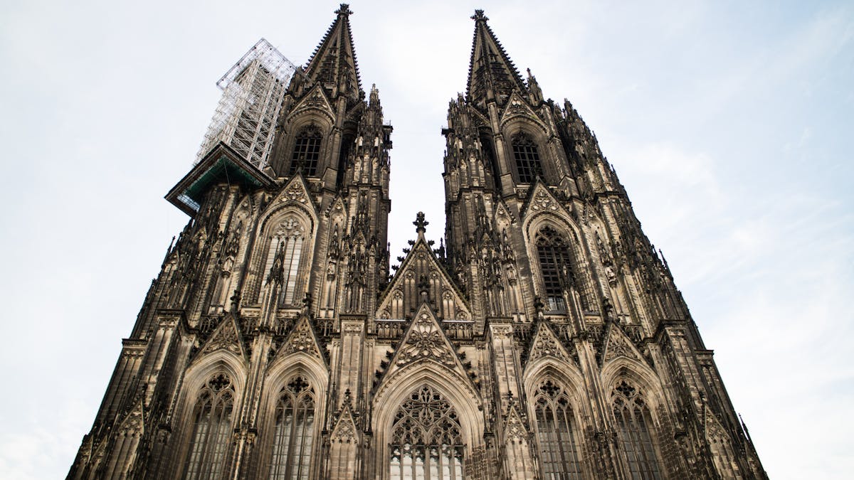 Gothic architecture of Cologne Cathedral in Germany against a clear sky