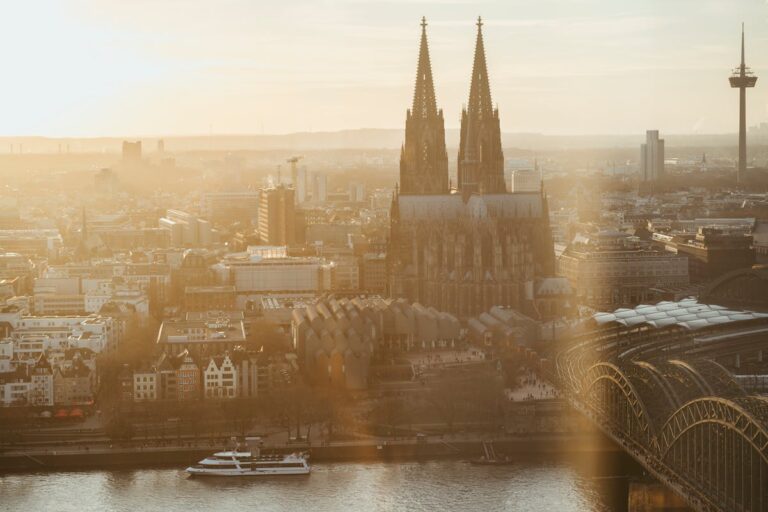 Aerial view of Cologne Cathedral with golden sunrise over the Rhine River