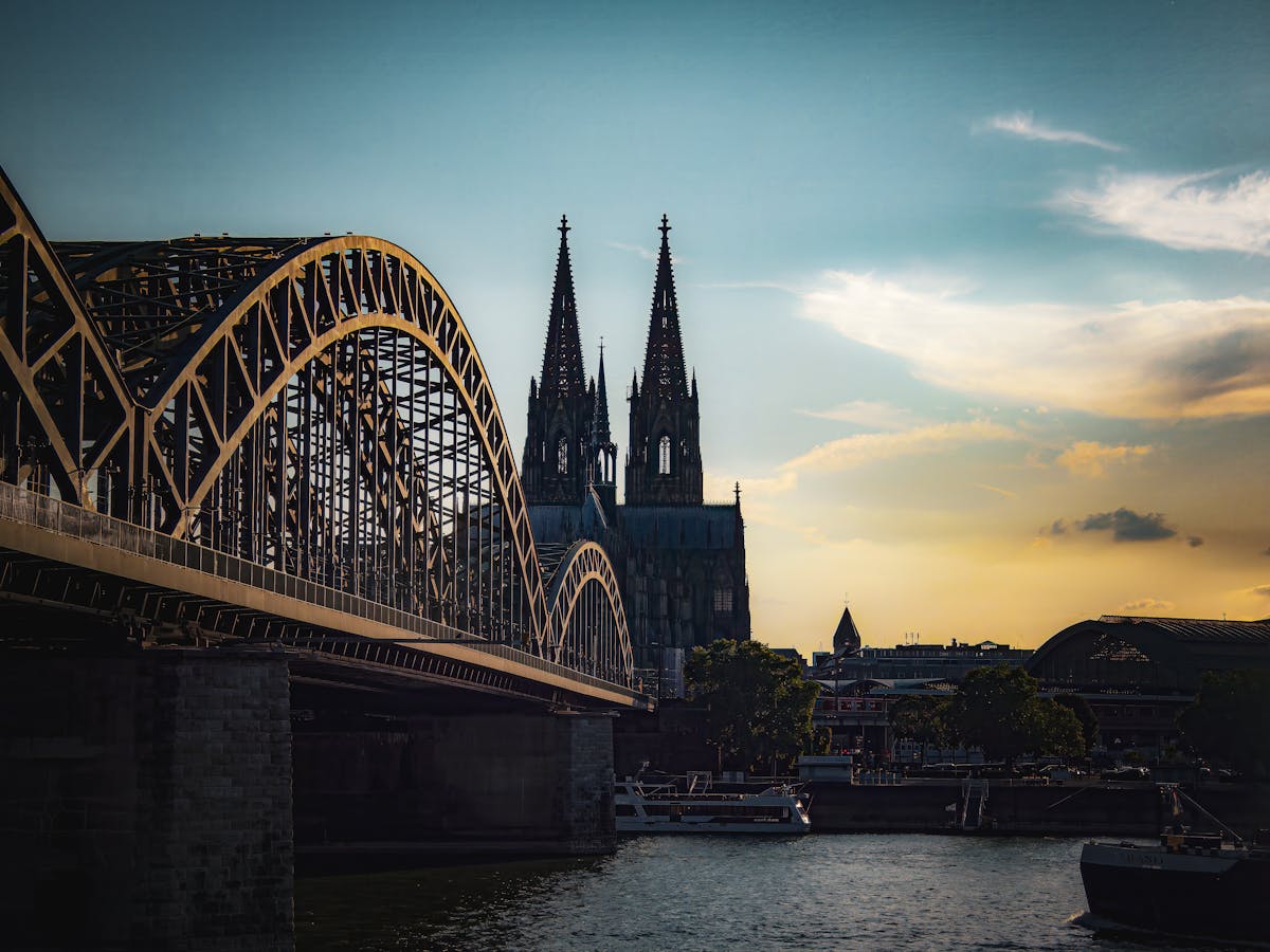 Sunset scene of Cologne Cathedral and Hohenzollern Bridge over the Rhine River