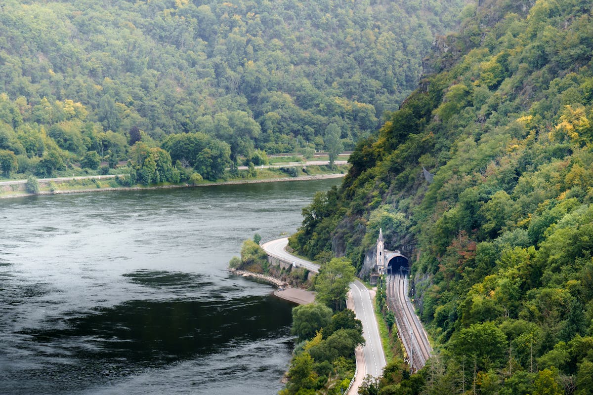 Aerial view of the Rhine River with a train tunnel through the hillside