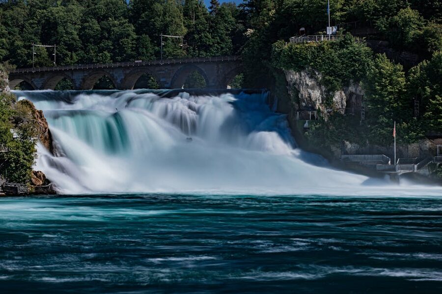 Rhine Falls with greenery and bridge in summer