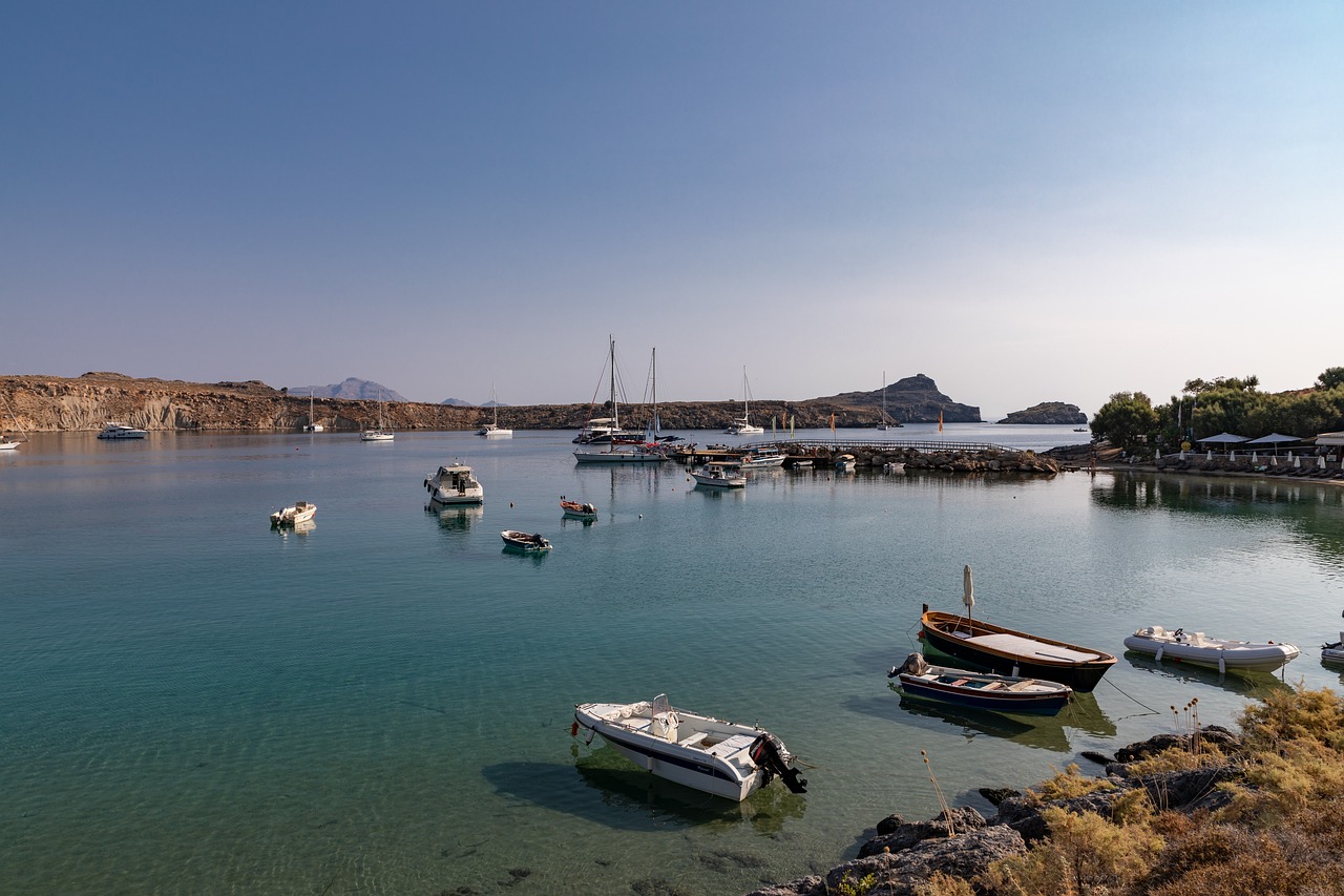 Boats in the port of Rhodes on calm blue water