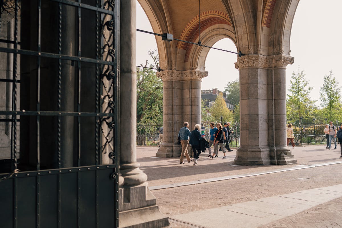 People walking through the monumental arches of the Rijksmuseum passage