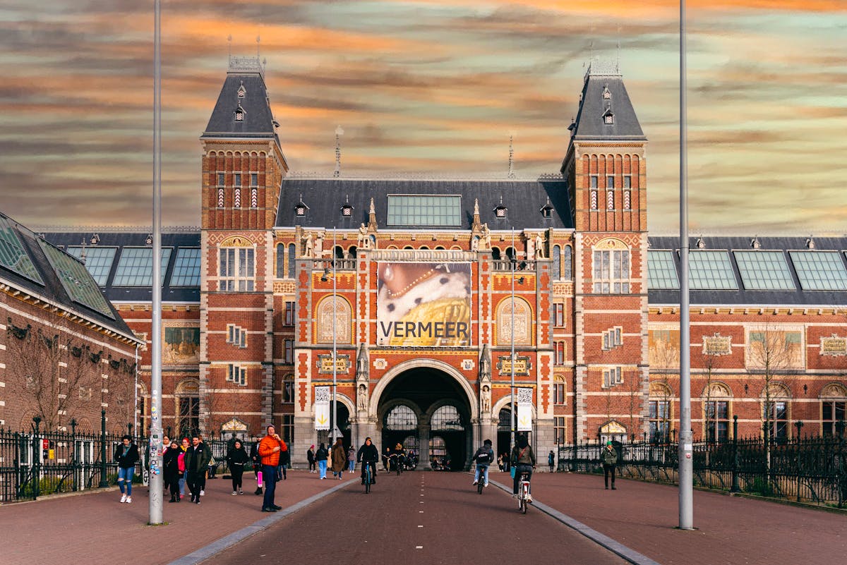 People entering the Rijksmuseum during golden hour sunset light