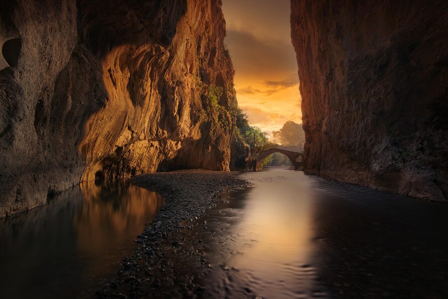 River flowing through a canyon with rocks and tall cliff formations