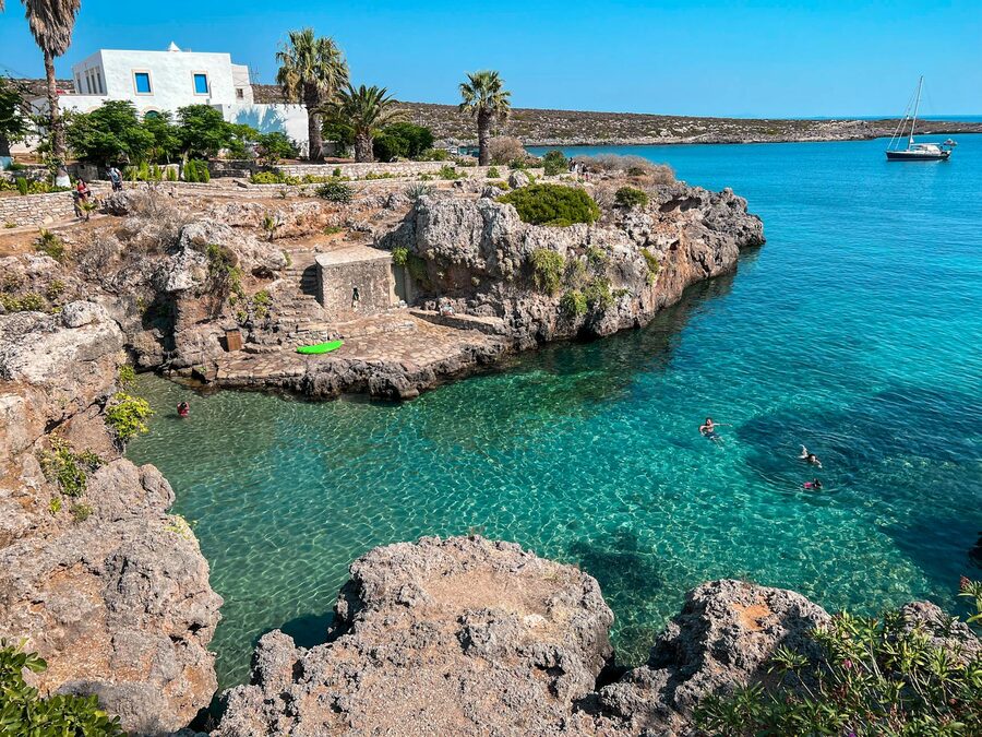 Rocky coastline with turquoise waters and lush greenery along the Mediterranean