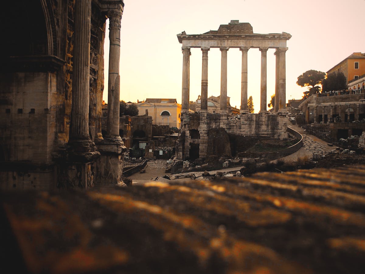 The Roman Forum in Rome at sunset with historic ruins