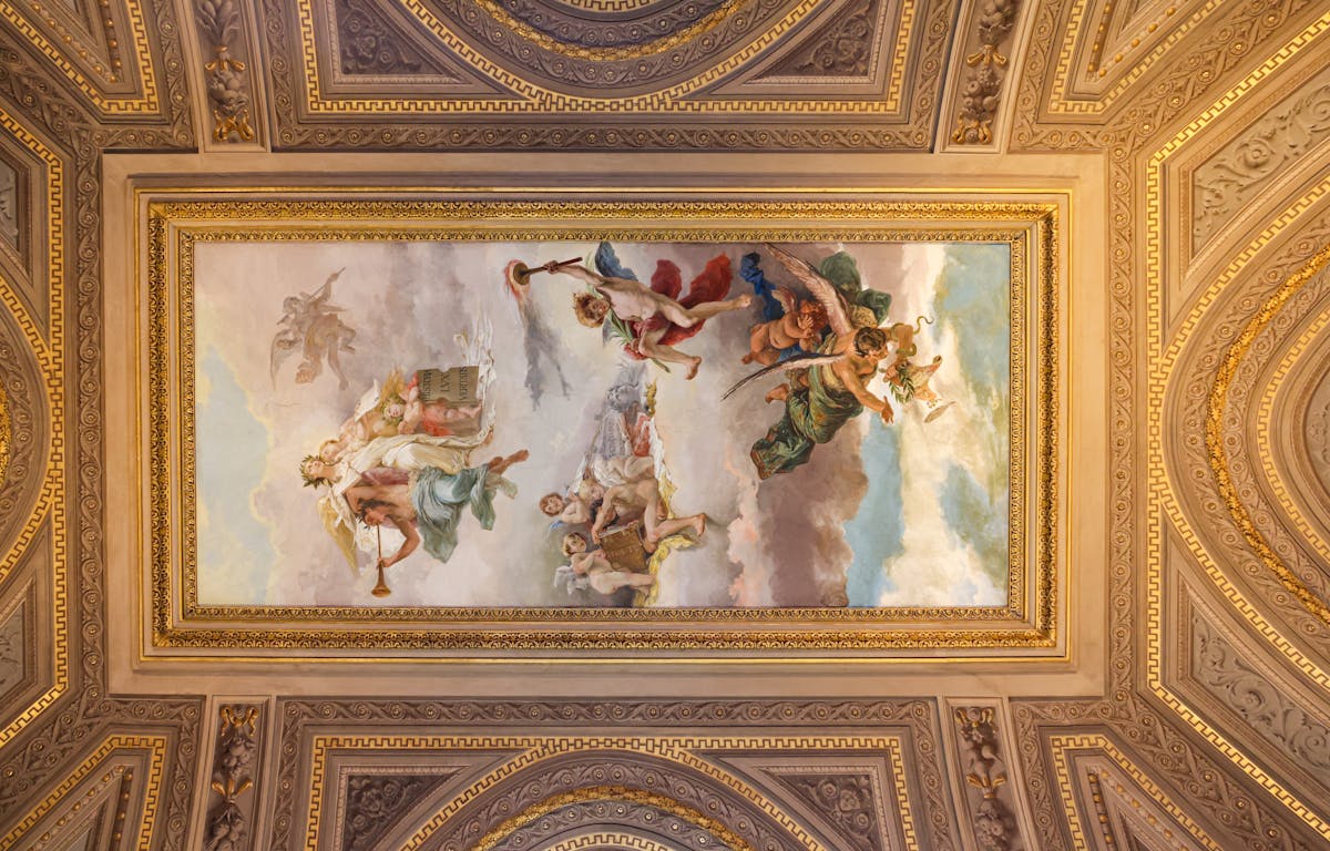 Painted frescoed ceiling with classical Roman art inside ornate architectural framing