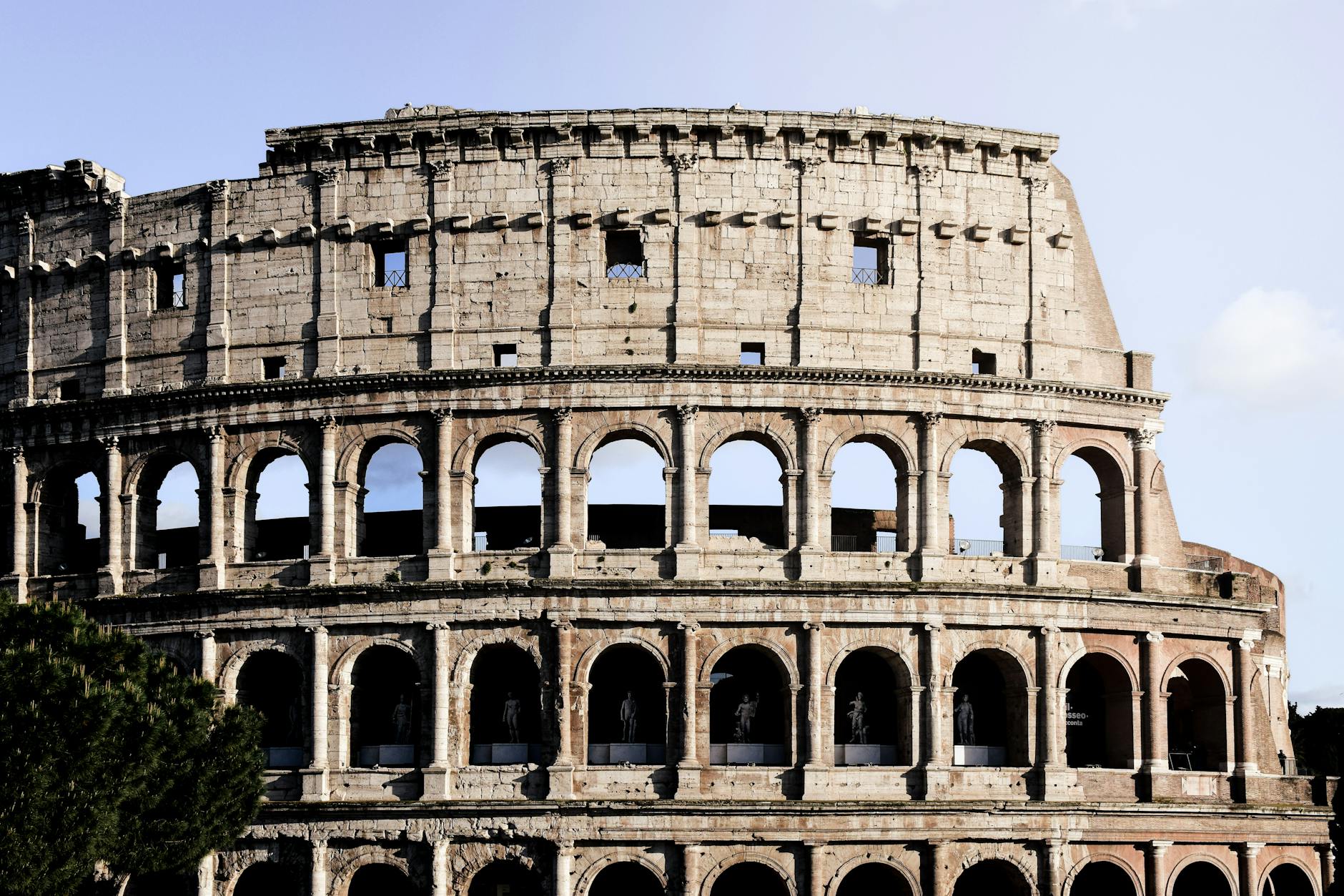 The Colosseum in Rome under blue sky