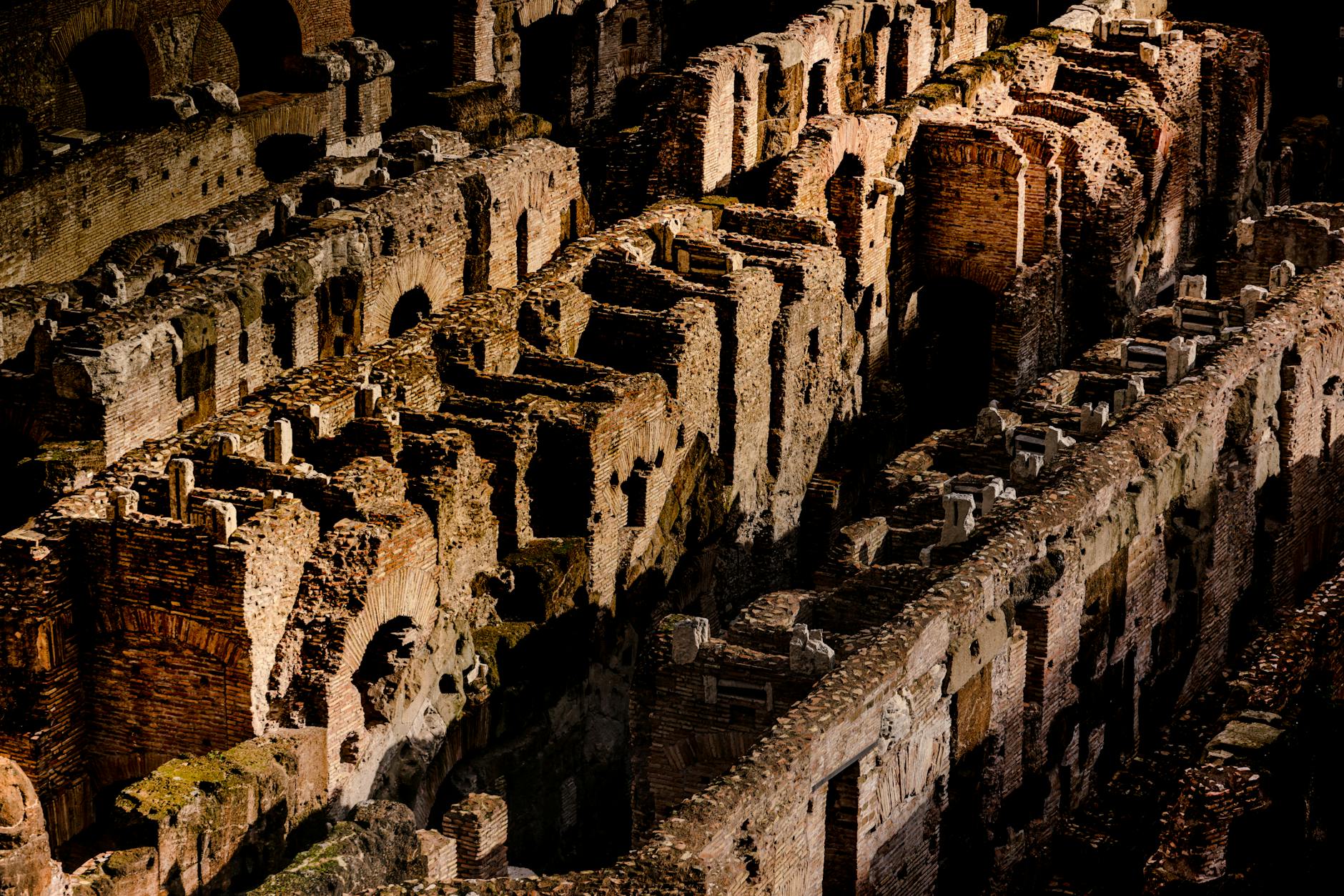 The Colosseum ruins illuminated at dusk in Rome