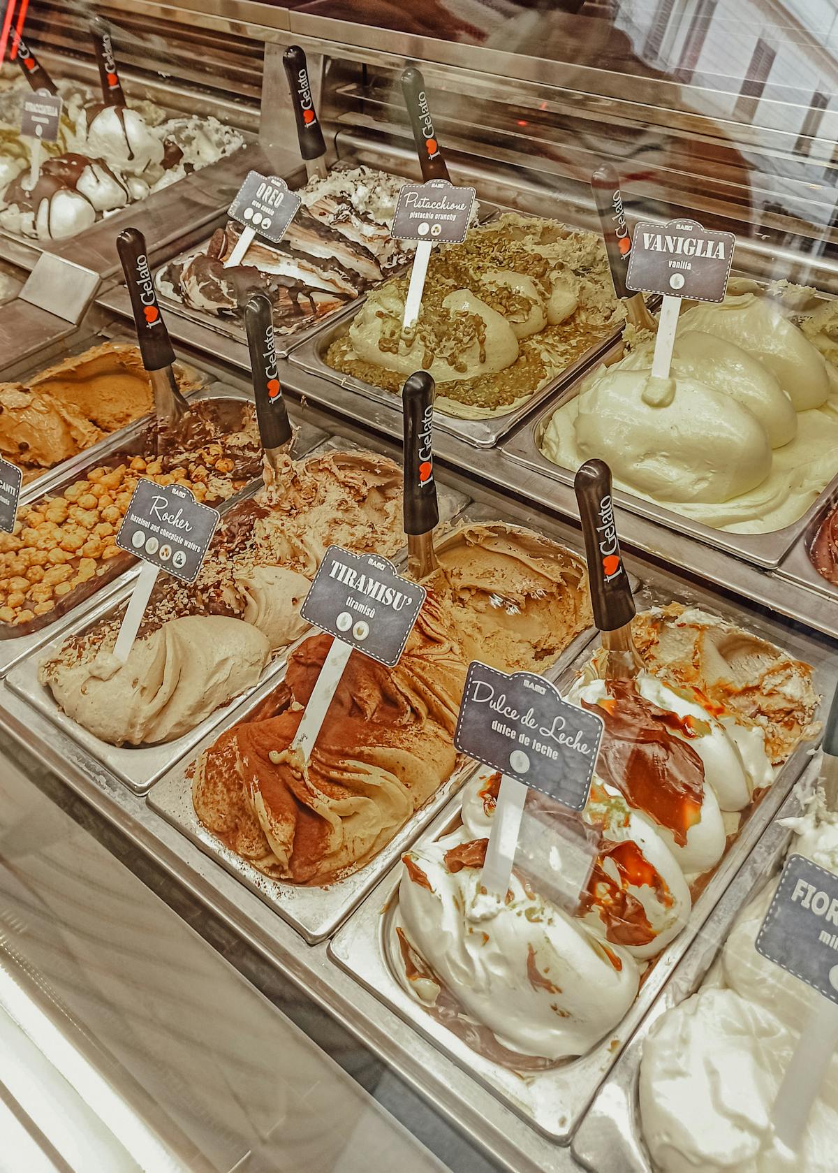 Wide selection of artisan gelato flavors on display in a Rome gelateria