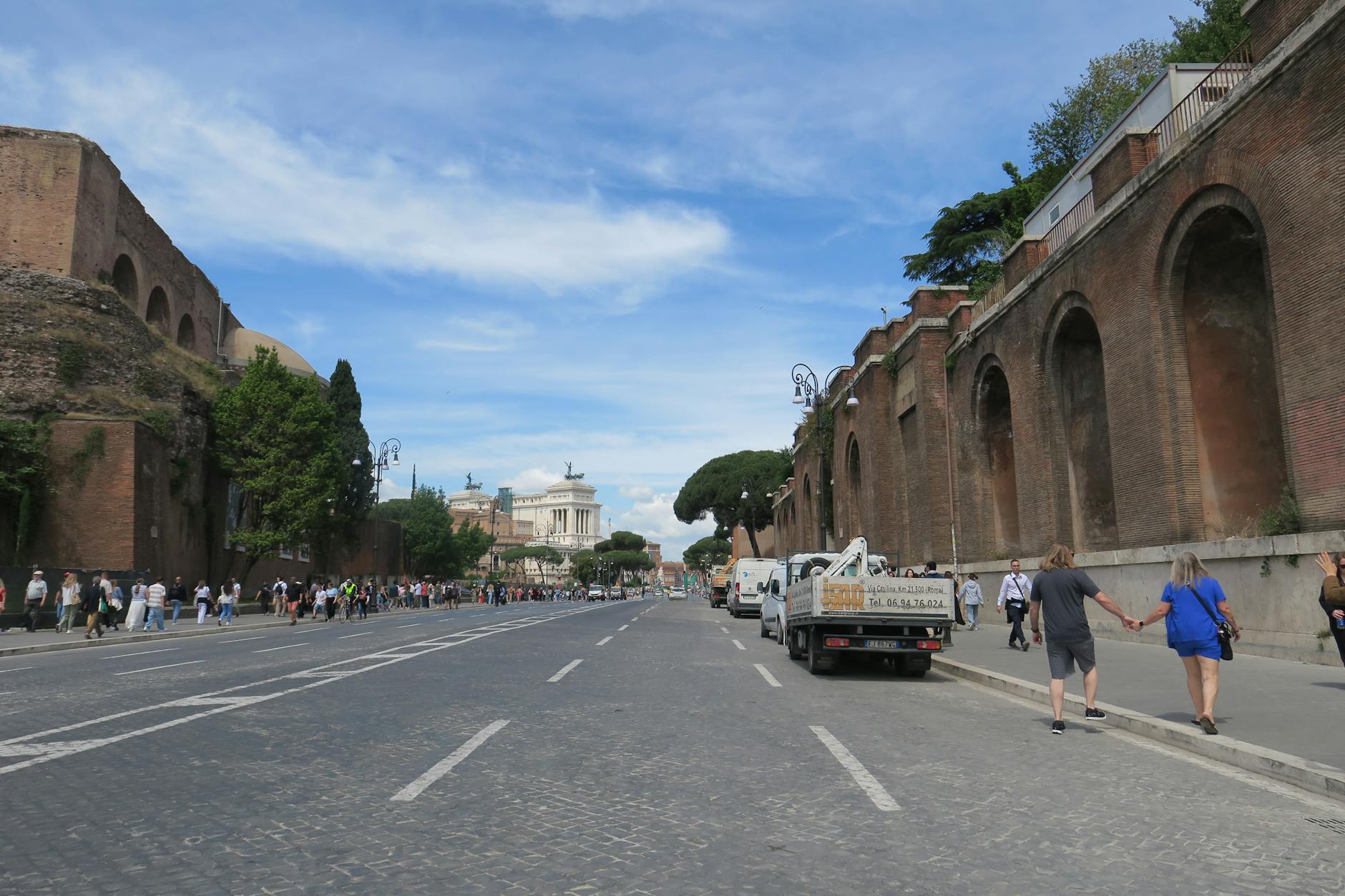 A street in Rome with ancient walls and view of Altare della Patria