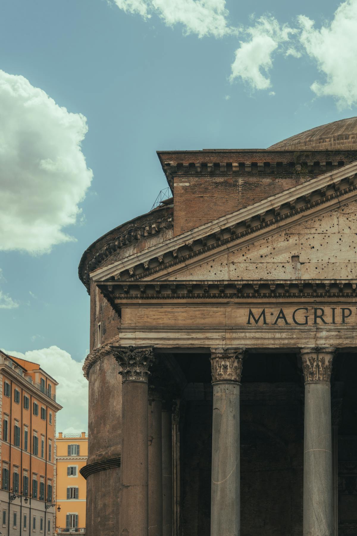 The Pantheon facade with cloudy sky in Rome