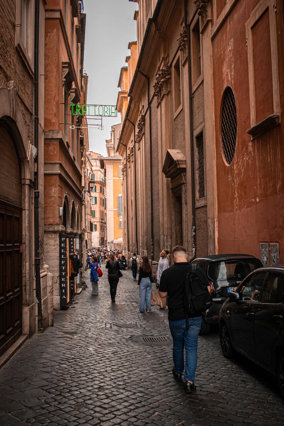 Pedestrians on a cobblestone street in central Rome