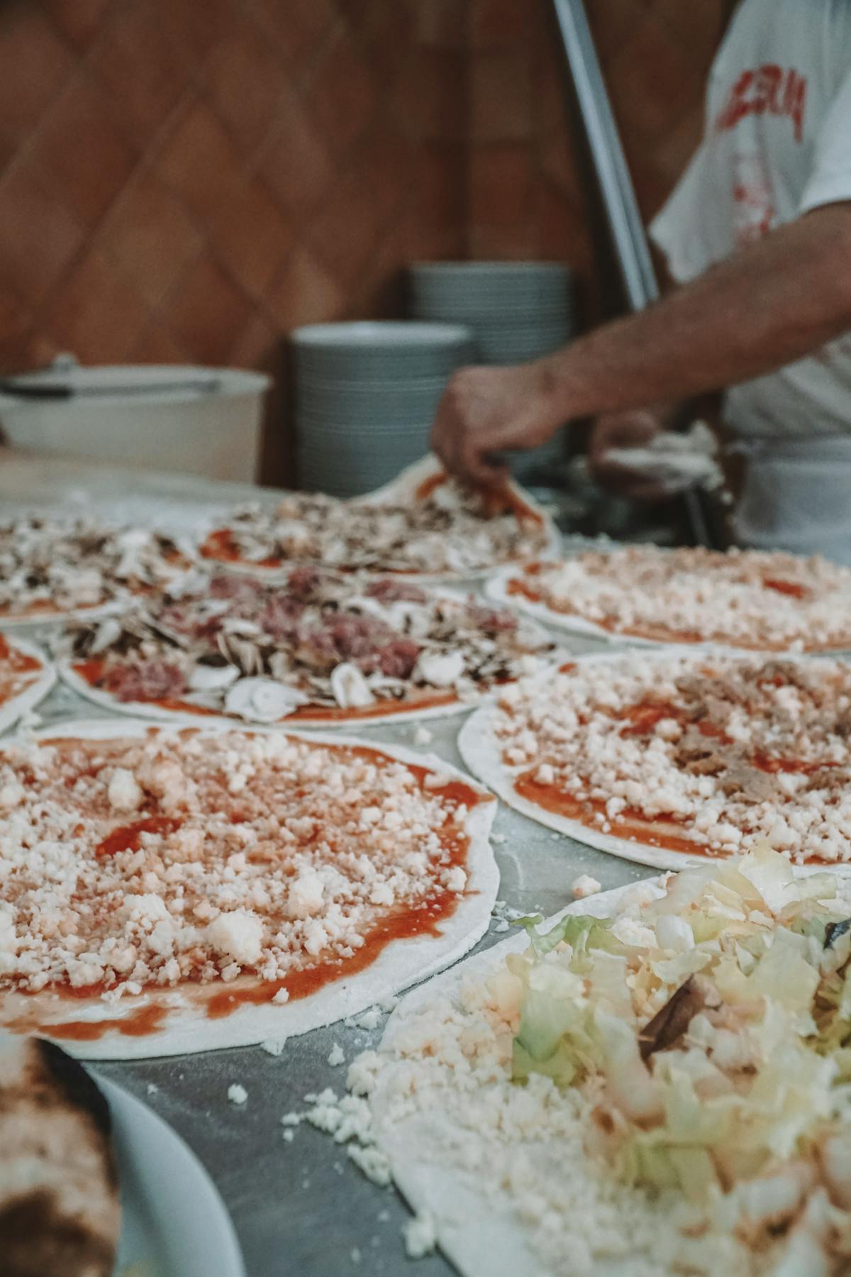 Authentic Italian pizzas being prepared in a Roman kitchen