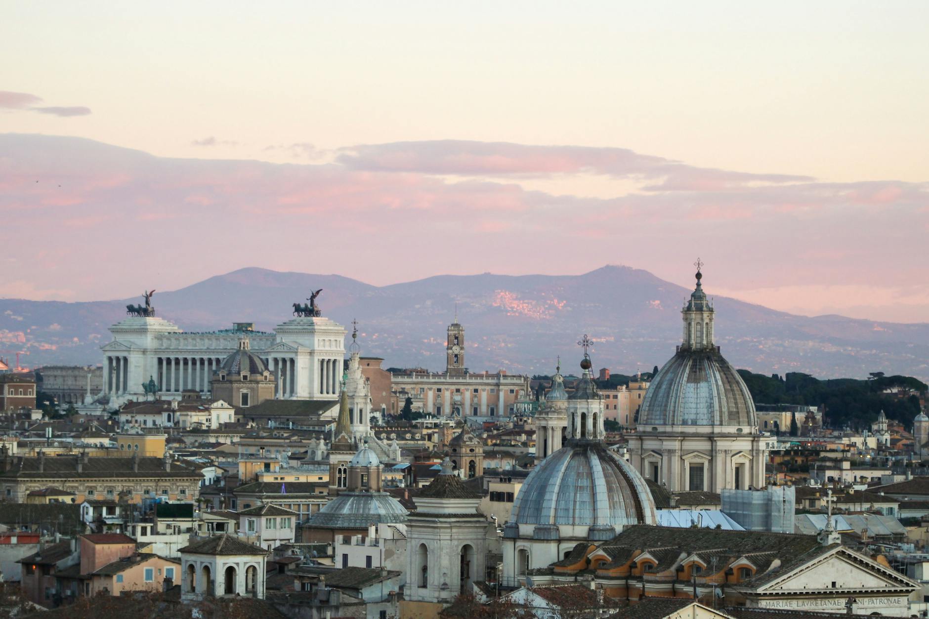 Panoramic view of Rome historic skyline with domes at sunset