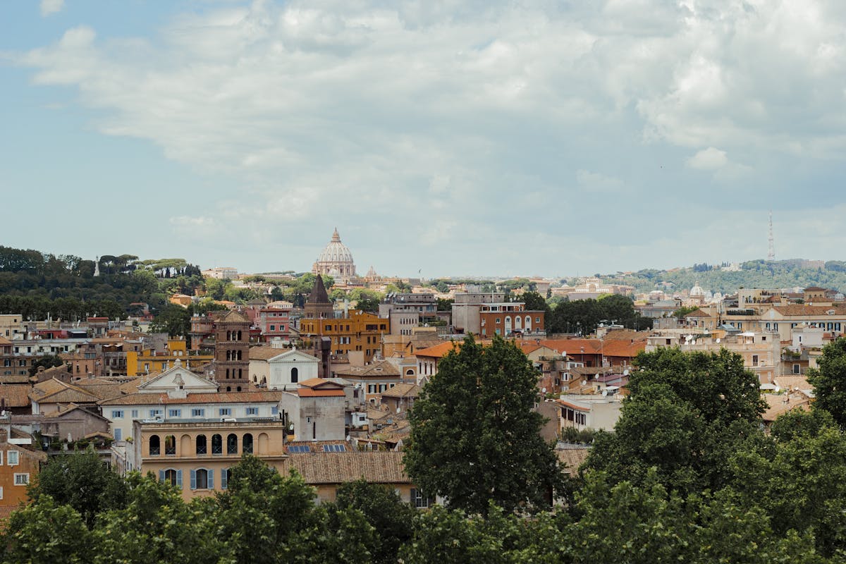 Rome cityscape featuring St Peters Basilica dome among historic architecture