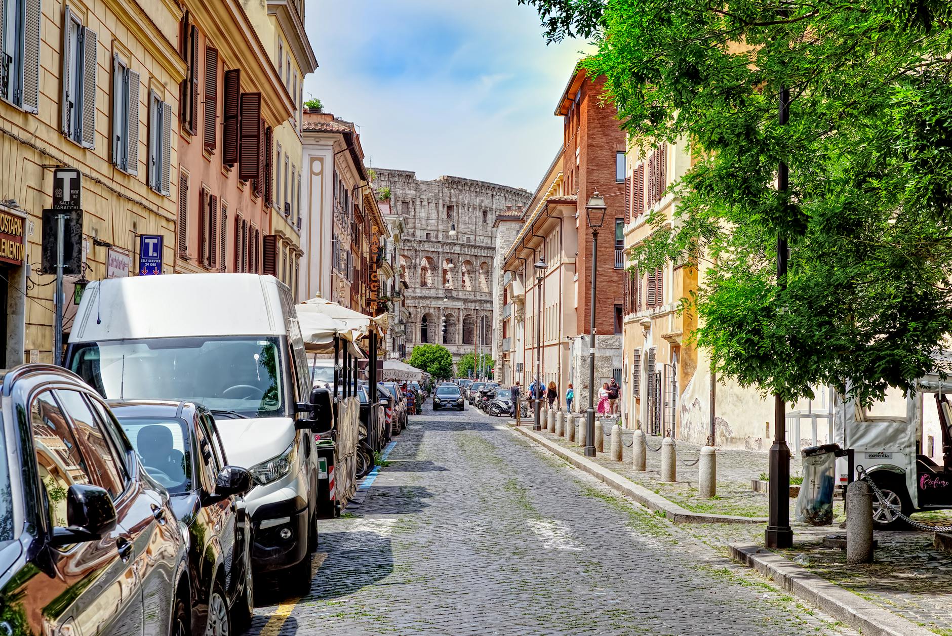 Charming Rome street with the Colosseum visible in the background