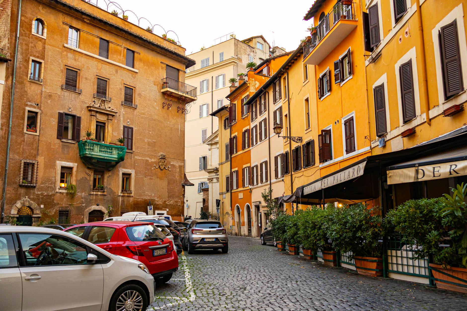 Historic architecture and parked cars on a Rome street