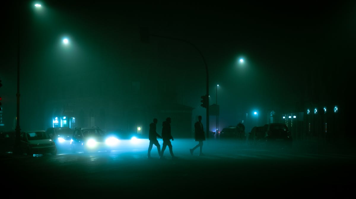 People walking on a Rome street at night