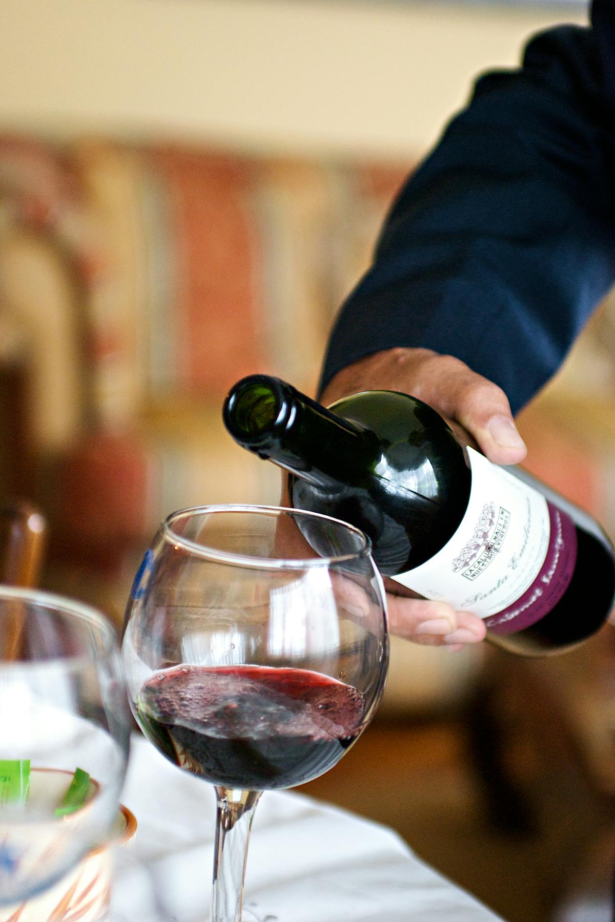 Waiter pouring red wine in an Italian restaurant