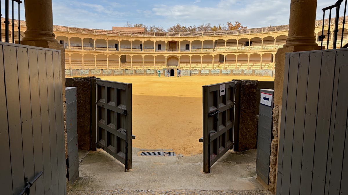 The historic bullring Plaza de Toros in Ronda Spain viewed through the open entrance gates