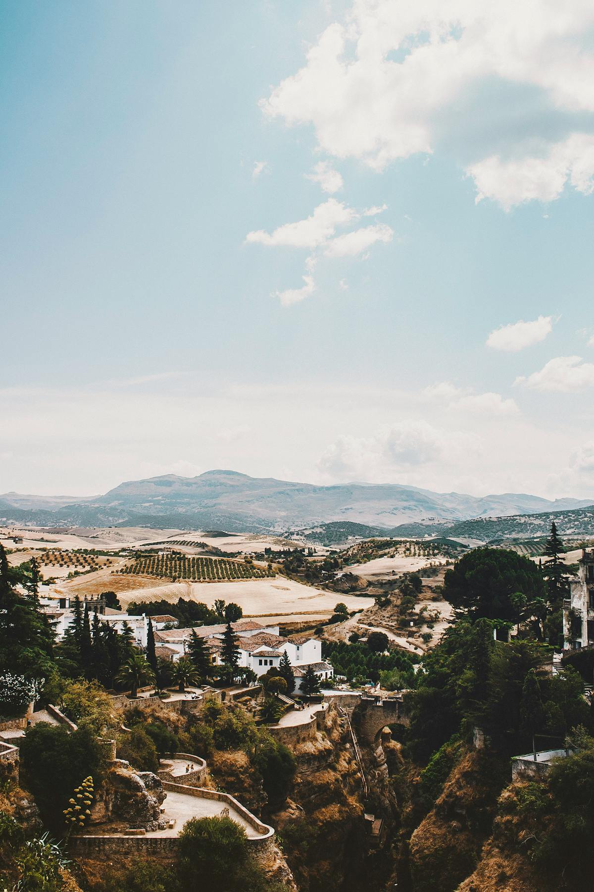 Rural countryside landscape near Ronda Spain with rocky cliffs olive trees and distant mountain ranges