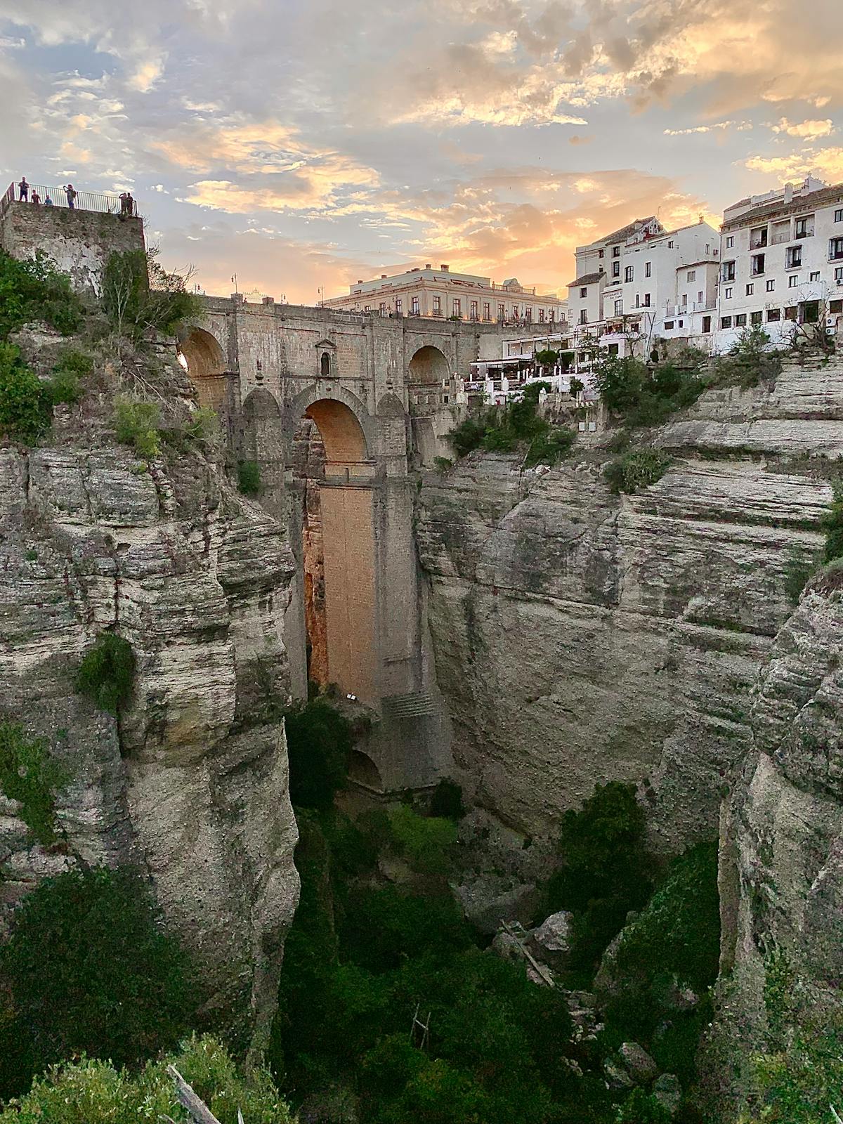 Puente Nuevo bridge in Ronda Spain at sunset with warm golden light on the limestone walls