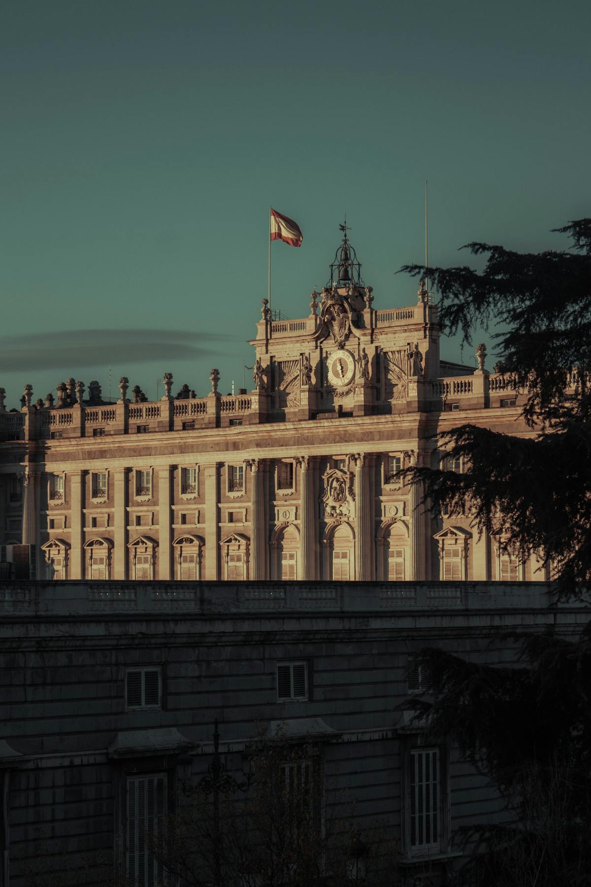 Atmospheric view of the Royal Palace of Madrid under dark clouds