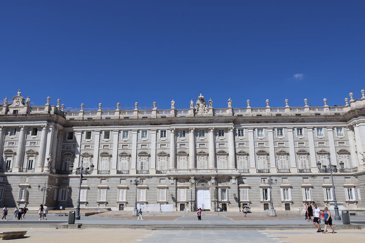 Front view of the Royal Palace of Madrid on a sunny day with clear skies