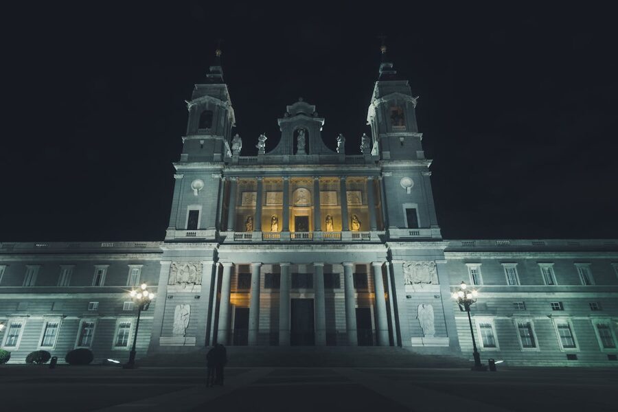 The front facade of the Royal Palace of Madrid lit up at night