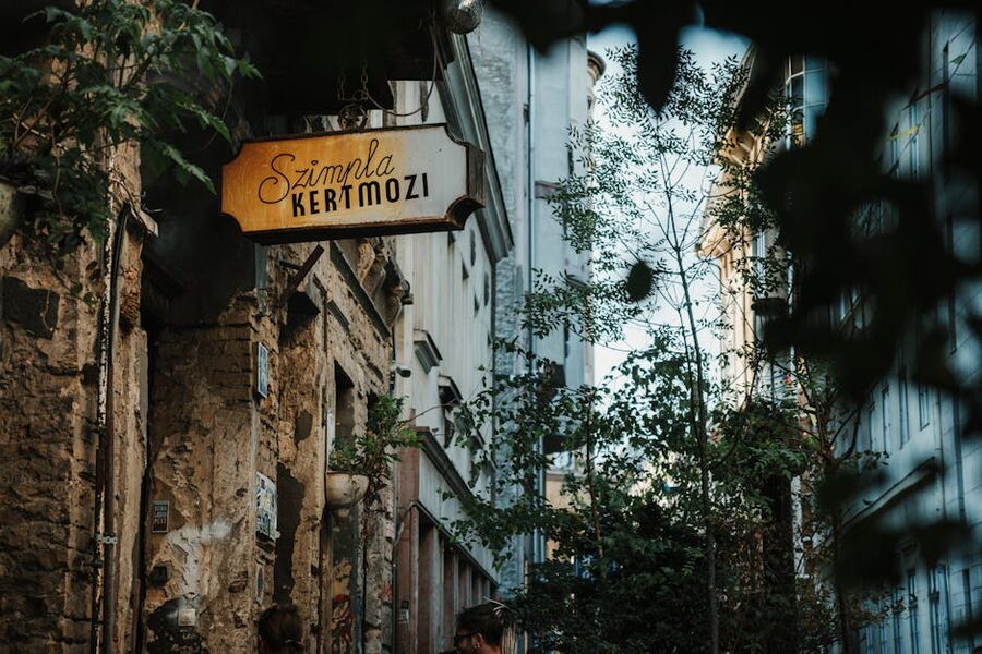Szimpla Kertmozi sign in a Budapest alley with the original ruin bar entrance