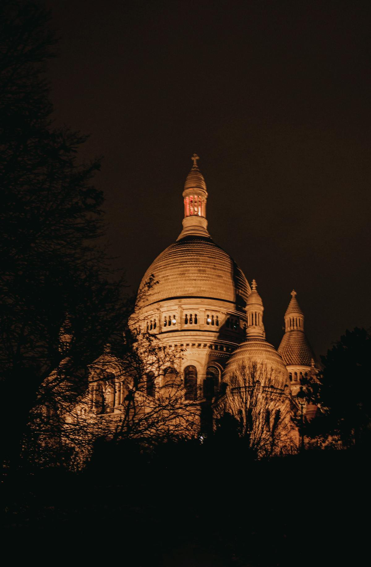 Sacre-Coeur Basilica illuminated at night against the Paris sky