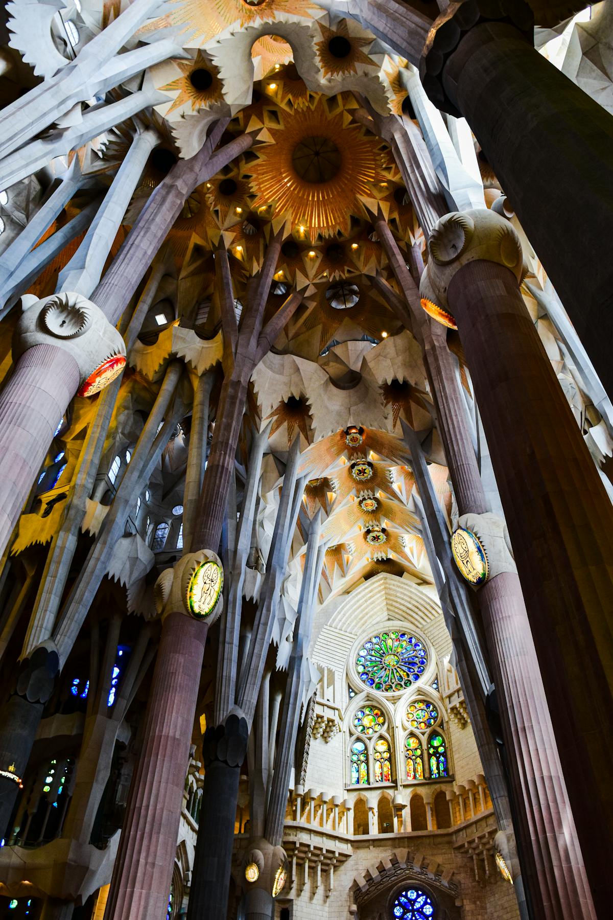Geometric star patterns on the Sagrada Familia ceiling where branching columns meet