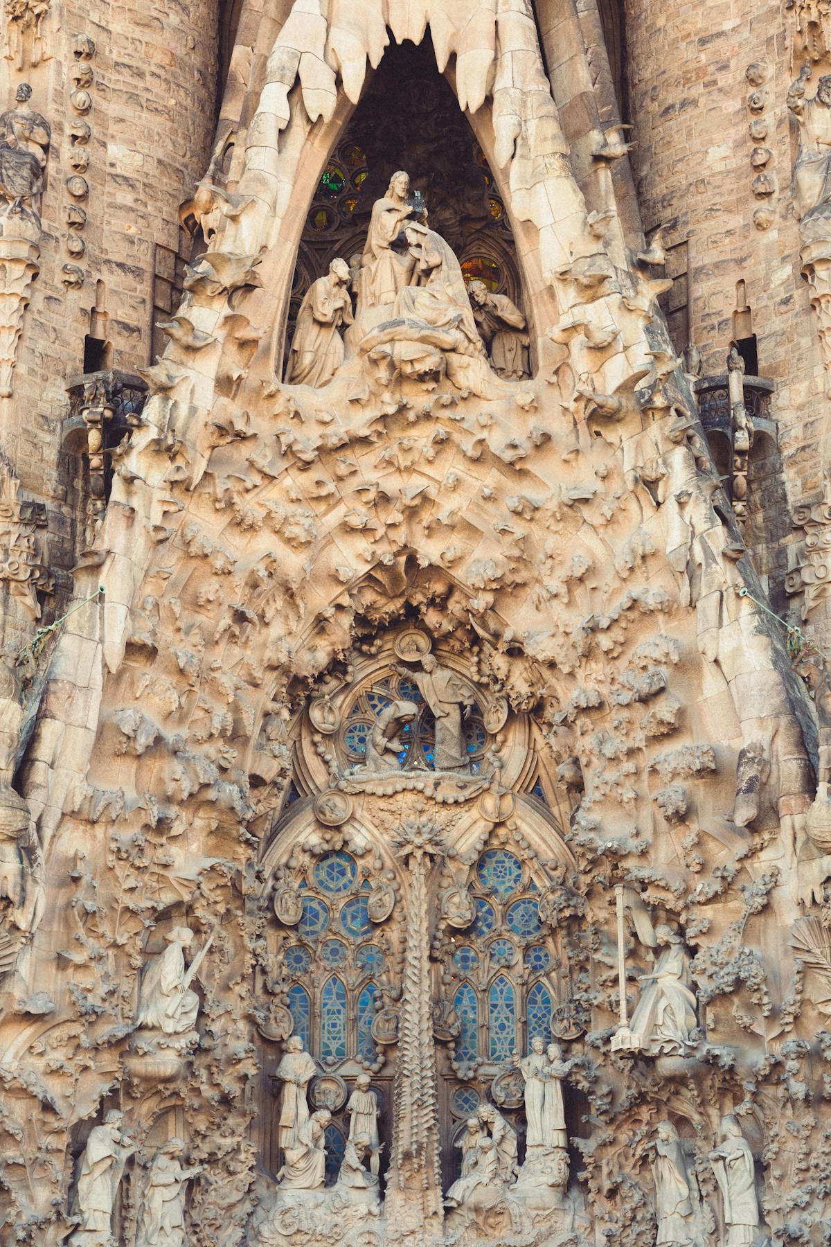 Close-up of ornate sculptural details on the Sagrada Familia facade showing biblical scenes carved in stone