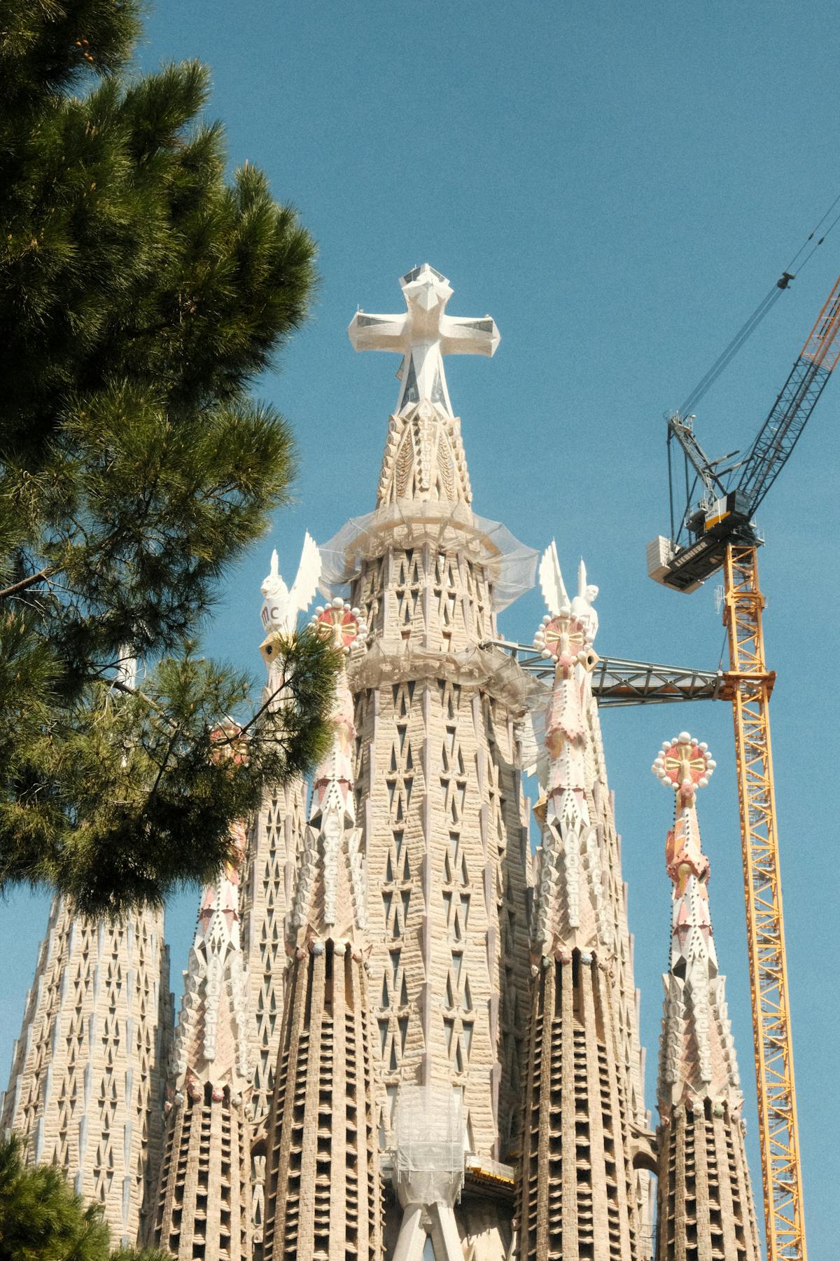 Sagrada Familia towers with construction crane showing ongoing building work