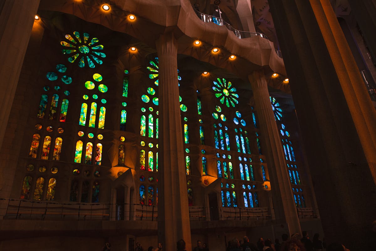 Vibrant stained glass windows creating a rainbow of coloured light inside Sagrada Familia