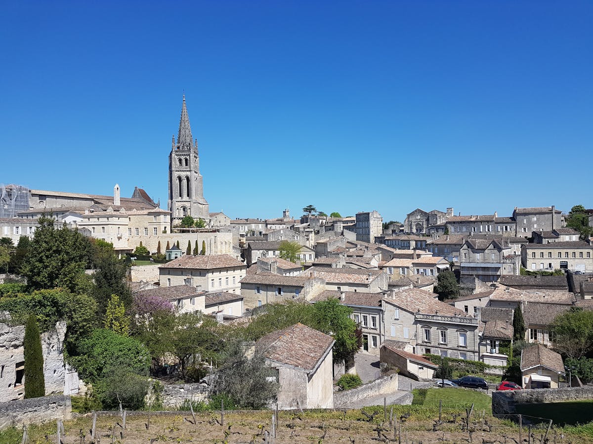 The historic monolithic church and bell tower rising above the medieval buildings of Saint-Emilion France