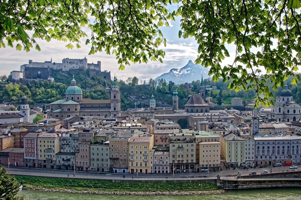Panoramic view of Salzburg with fortress on the hilltop and Alps behind