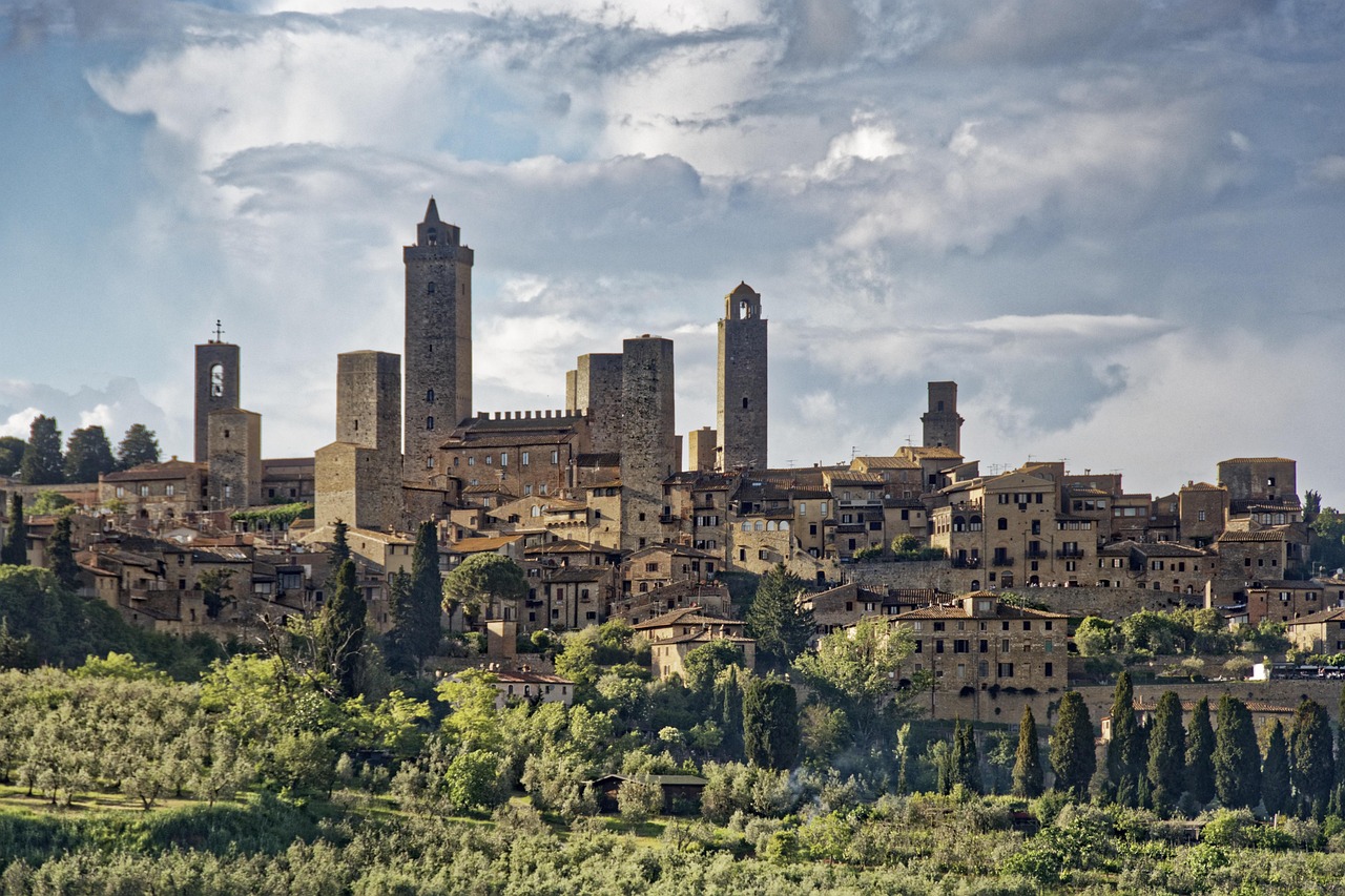 Historic center of San Gimignano with towers overlooking the green Tuscan valley