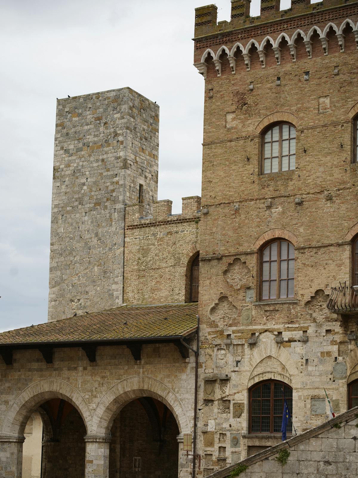 Stone towers and medieval architecture lining a street in San Gimignano