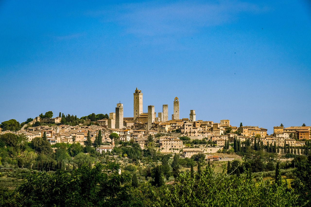 Wide panoramic view of San Gimignano towers and the surrounding Tuscan countryside