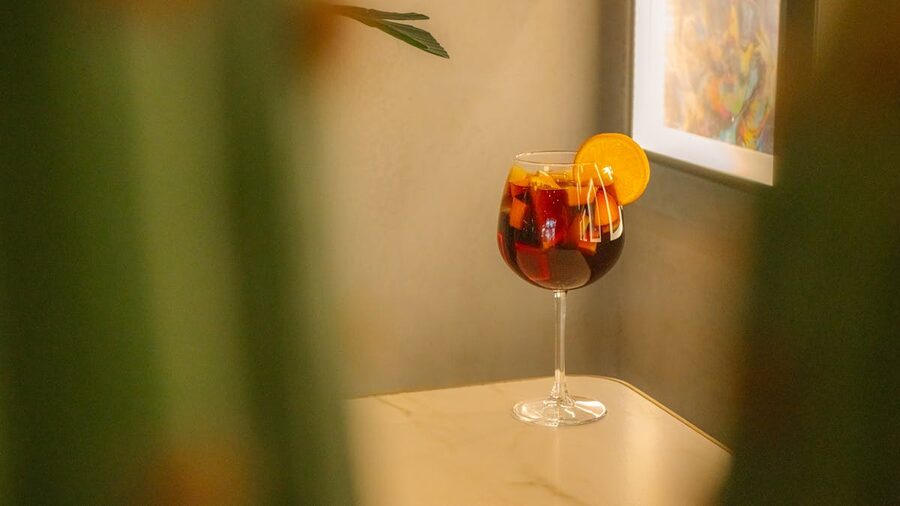 Elegant glass of sangria with orange slice on marble table