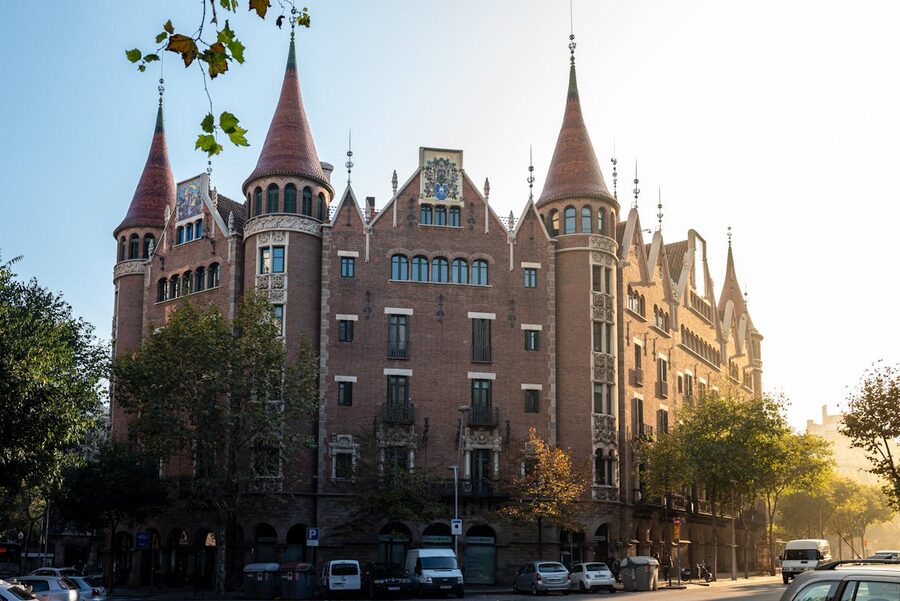 Exterior of a historic Gothic brick building at Sant Pau under clear blue sky