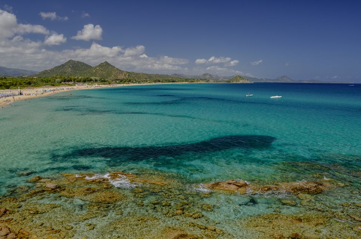 Turquoise blue waters and sandy beach along the coast of Sardinia Italy