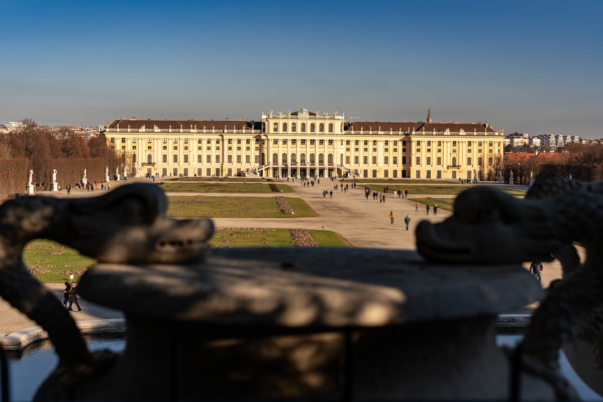 View of Schonbrunn Palace from the formal gardens with hedge-lined pathways