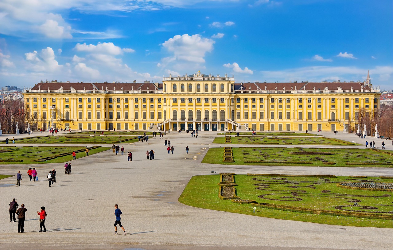 Tourists exploring the vast gardens and pathways at Schonbrunn Palace