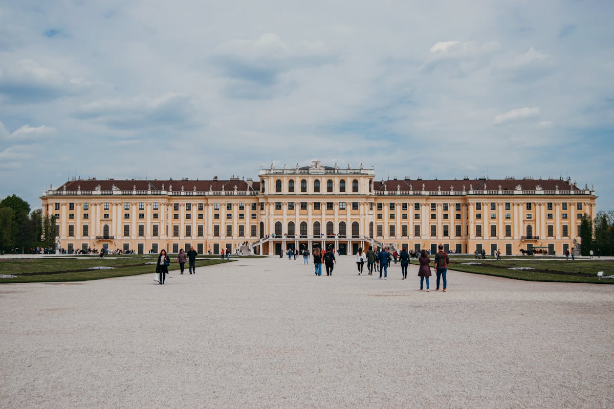 Tourists walking through the grounds of Schonbrunn Palace