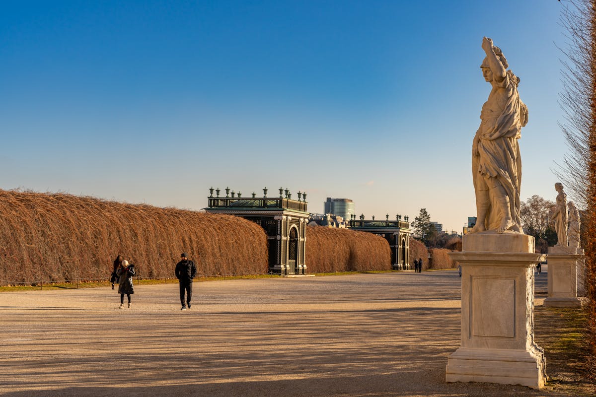 An elegant stone statue in the formal gardens of Schonbrunn Palace